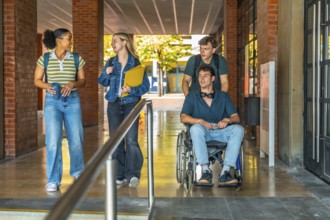 Group of young students, including one young man using a wheelchair, navigating an accessible
