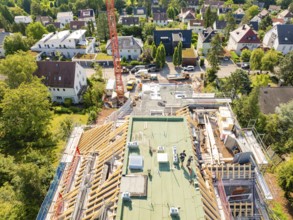 View from above of a building under construction with a view of an urban scene, carpentry