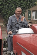 Farmer on his Schlüter tractor, Tauchersreuth, Middle Franconia, Bavaria, Germany
