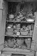 Collected objects in a former rabbit stable on a former Franconian farm, black and white,