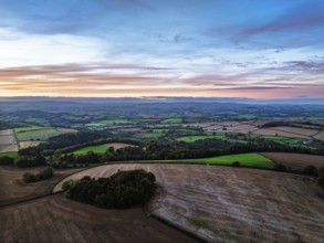 Sunset of Devon Farms and Fields over Berry Pomeroy from a drone, Totnes, England, United Kingdom