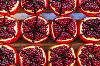 Pomegranate (Punica granatum), halved with red seeds, fruit, food, stand at the Asiatic Riverfront,