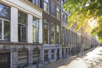 Holland, Amsterdam canals with boats, scenic bridges and historic city center, UNESCO World