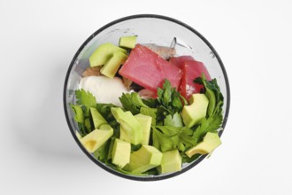 Smoked tuna fillets, avocado, greek yoghurt and parsley in a bowl of hand blender. This healthy