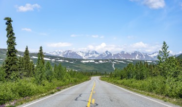 Road through taiga and mountainous landscape, picturesque landscape on Richardson Highway, Alaska,