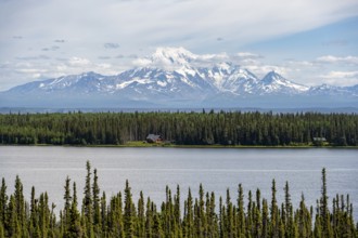 House on Lake Willow Lake, Taiga landscape with high glaciated mountain peak Mount Drum, Wrangell