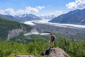 Young woman enjoying the view, view of impressive mountain landscape with Matanuska glacier and