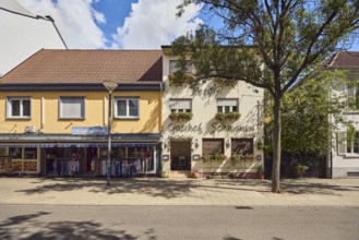 Gasthof Schwanen, Cheema fashion store, commercial building, lantern, city trees, blue sky, cumulus
