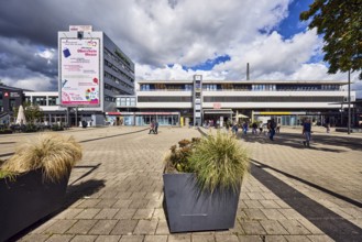 Train station, modern architecture, apartment building, concrete paving stone walkway, pedestrian