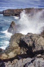 Coastal scene with waves breaking against rocks under a cloudy sky, Playa del Janubio, Yaiza