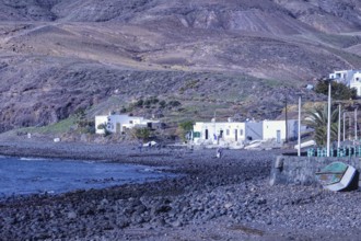 Small houses along a rocky coastline with a deep blue sea, Playa Quemada, Yaiza Lanzarote
