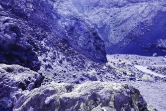 Dry, rocky terrain with rocky formations and soft lighting conditions, El Cuervo volcanic crater,