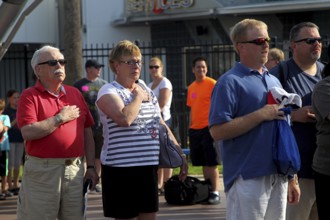 People at the entrance to the Kennedy Space Center during the national anthem, Merritt Island,
