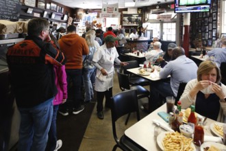Bustling restaurant with guests and staff enjoying typical southern cuisine, New Orleans,