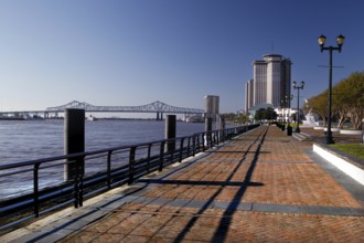 Promenade with high-rise building on the riverbank under clear sky, New Orleans, Louisiana, USA