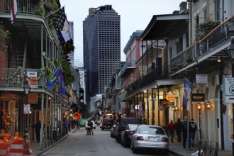 Nocturnal street scene in the French Quarter with illuminated buildings and cars, New Orleans,