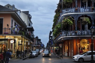 Night view of a busy street in the French Quarter with illuminated shops, New Orleans, Louisiana,