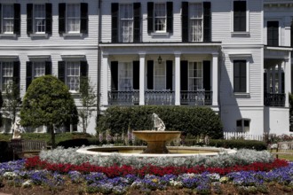 Nottoway Plantation mansion with decorative fountain and colorful flower bed, zero