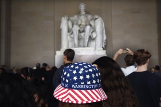 Visitors look at the Lincoln statue, some wearing patriotic clothes, Washington D.C, USA
