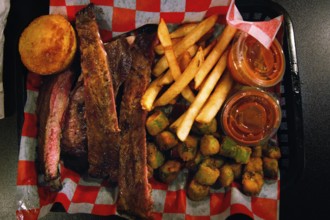 BBQ meal with ribs and side dishes on a tray in a restaurant, Savannah, Georgia, USA
