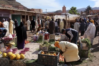 People buy and sell vegetables at a market in Msemrir, Msemrir, Morocco