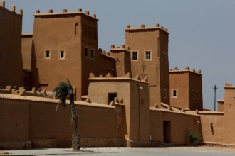 Impressive traditional architecture of Kasbah Taourirt with towers against a clear sky, Ouarzazate,