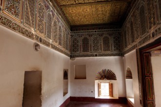 Richly decorated interiors of Kasbah Taourirt with ornate ceilings and traditional Moroccan