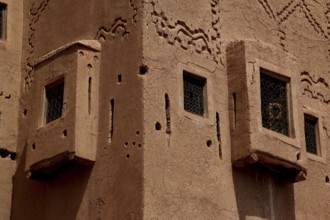 Kasbah with ornately decorated mud-brick window openings and decorative patterns, Ouarzazate,