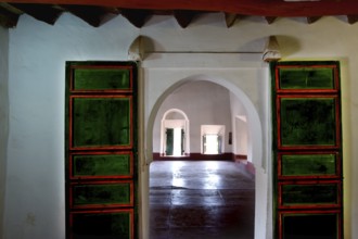 Interior view of a kasbah with colorful glass windows and arched doors, Ouarzazate, Kasbah