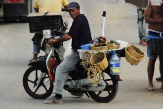 Street vendor on a motorcycle with baskets full of oysters in Oulidia, Oulidia, Doukkala-Abda,