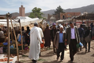 Market scene in Msemrir with people walking along the stalls, Msemrir, Morocco