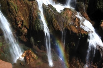 Ouzoud waterfalls with an impressive rainbow over the bubbling waters, Ouzoud, Morocco