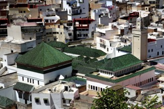View over the roofs of Moulay Idris dominated by green tile roofs and minarets, Moulay Idris,