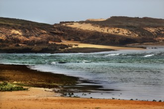 Wild coastal landscape on Oulidia beach with rough seas and windswept coast, Oulidia,