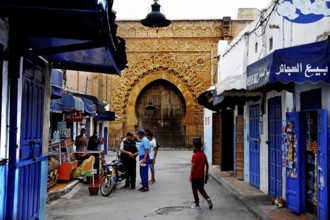 Historic street in the Kasbah des Oudaias with archway and blue facades, Rabat, Morocco