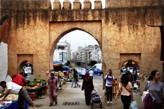 Bustling market gate in the Medina of Rabat with lots of people and stalls, Rabat, Morocco