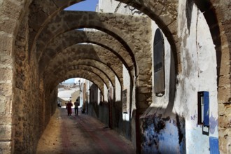 Archways with stone structure and atmospheric strips of light in the medina of Safi, Safi,