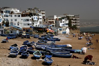 Fishing boats on Taghazout beach surrounded by buildings, Taghazout, Souss-Massa, Morocco