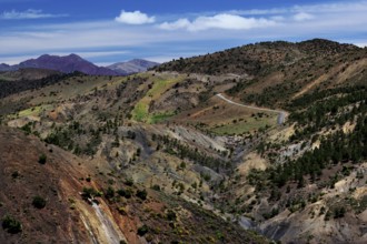 Serpentine road through the mountainous landscape of the High Atlas Mountains, surrounded by