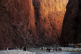 People explore the narrow Todra Gorge under light and shadow, Todra, gorge, narrowest point