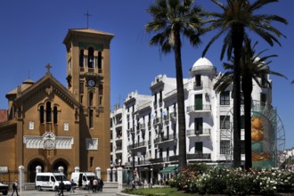 Historic buildings and church on Place Moulay el Mehdi, surrounded by palm trees, Tetouan, Morocco