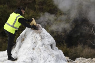 A human activates the Lady Knox geyser in the Wai-O-Tapu geothermal area