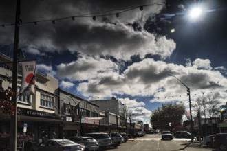 Busy Tutanekai Street in Rotorua with pedestrians and clouds under the bright blue sky, Rotorua,