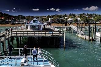 Russell Harbour with jetties and boats on blue water, Russel, Northland, New Zealand