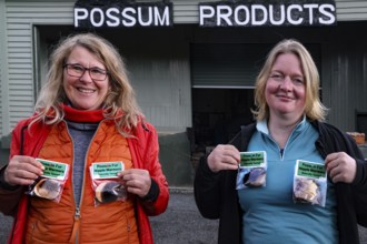 Two woman hold Possum products in front of the Possum Factory in Stratford, Stratford, New Zealand