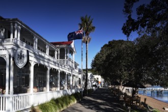 Duke of Marlborough Hotel in Russel, historic architecture with flag and palm trees, Russel,