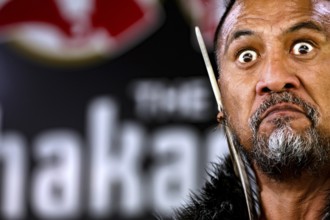 Close-up of a Maori man with intense expression during a cultural performance, Rotorua, Bay of