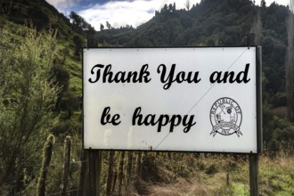 Sign in Whangamomona with the message 'Thank you and be happy' in a natural setting, Whangamomona,