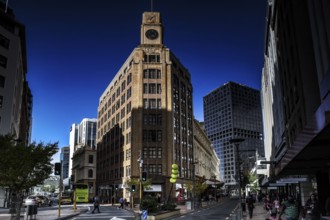 Historic building with clock tower and modern buildings in clear skies on Lambton Quay, Wellington,