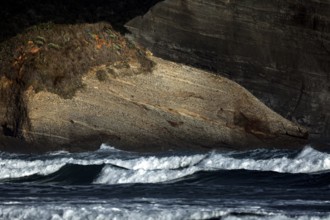 Natural, rough rocks on Wharariki Beach, washed by the sea, Wharariki, Tasman, New Zealand